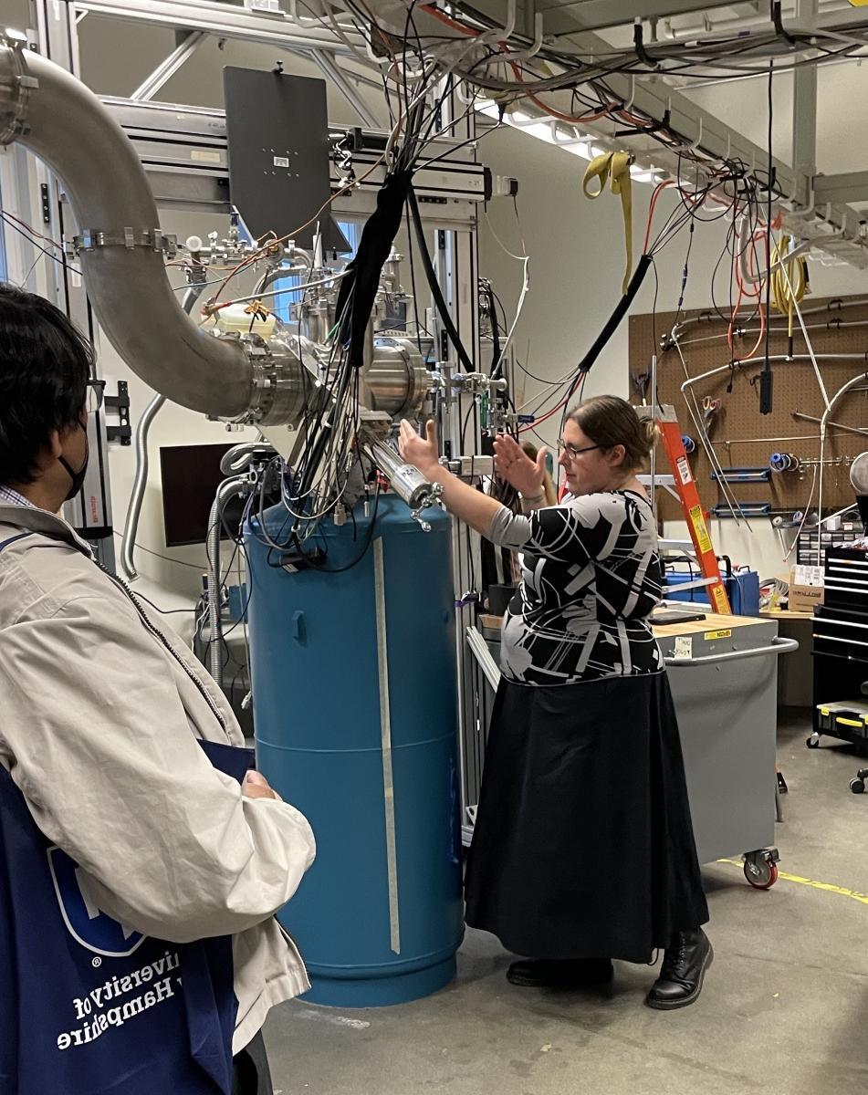 UNH physicist Elena Long stands in front of polarized target lab