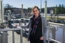 Paula Mouser stands on catwalk at Durham's wastewater treatment facility